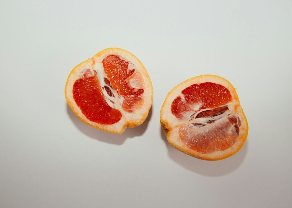 2 slices of Grapefruit known as a natural antibiotic with a white background