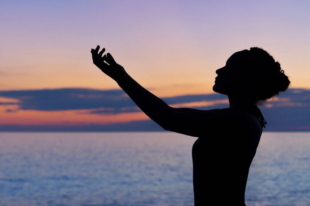 girl practicing yoga during sunset